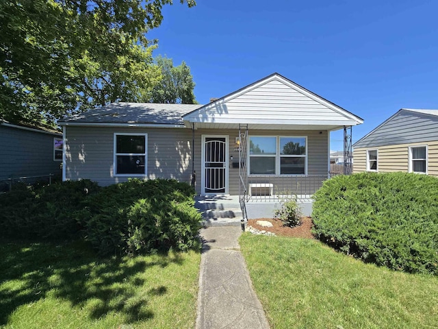 1117 E Garland Ave, Spokane, WA 99207 - view of front facade with a porch and a front lawn