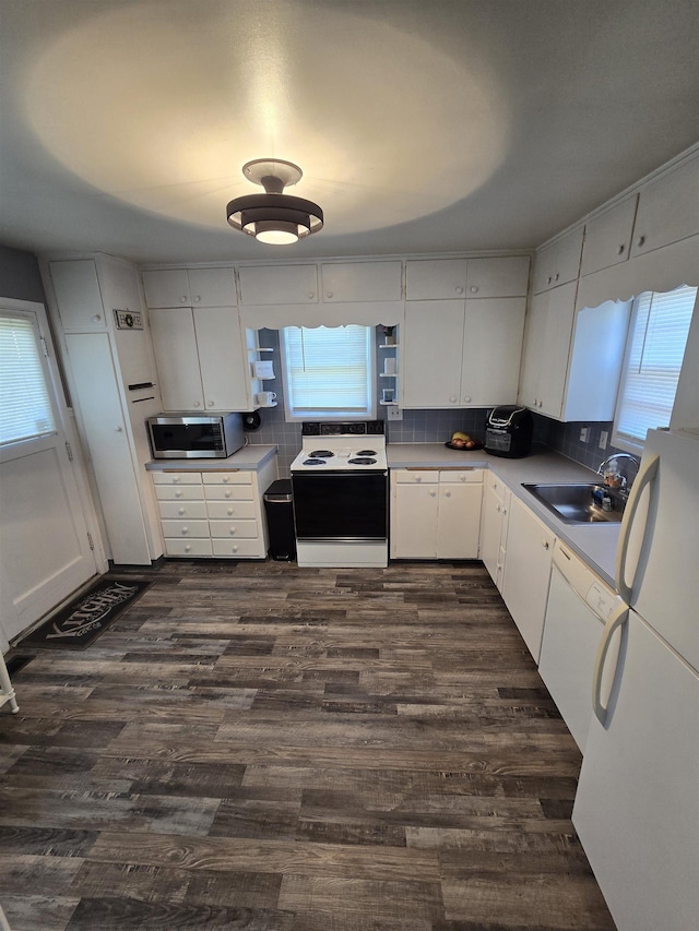 1117 E Garland Ave, Spokane, WA 99207 - kitchen with electric range, stainless steel microwave, white cabinets, and dark wood-style floors