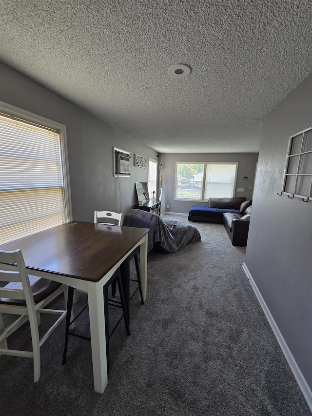 1117 E Garland Ave, Spokane, WA 99207 - dining area featuring carpet floors, a textured ceiling, an AC wall unit, and baseboards