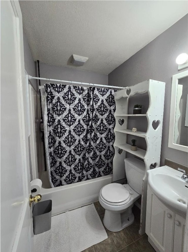 1117 E Garland Ave, Spokane, WA 99207 - full bath with shower / tub combo, vanity, toilet, tile patterned flooring, and a textured ceiling