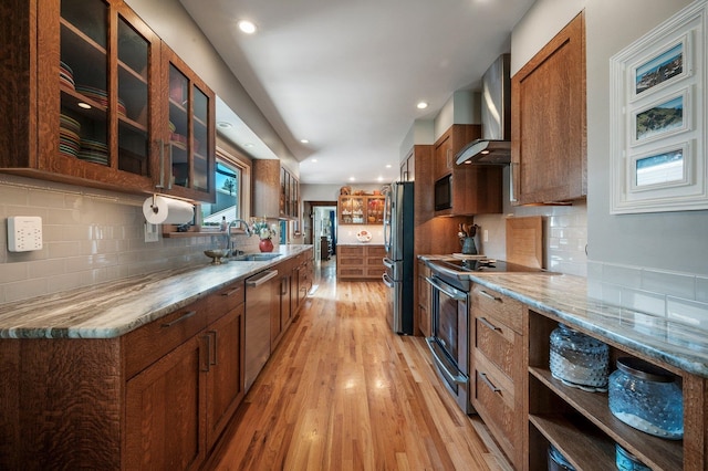 934 E 38th Ave, Spokane, WA 99203 - kitchen with stainless steel appliances, light wood finished floors, wall chimney range hood, tasteful backsplash, and recessed lighting