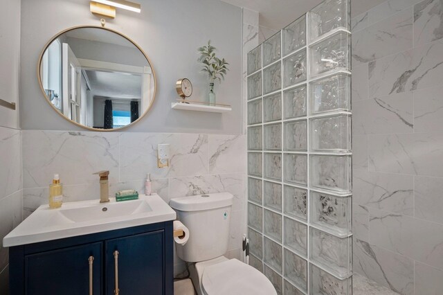 934 E 38th Ave, Spokane, WA 99203 - full bath featuring walk in shower, vanity, and tile walls