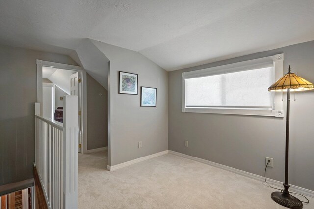 934 E 38th Ave, Spokane, WA 99203 - unfurnished bedroom with vaulted ceiling and light carpet