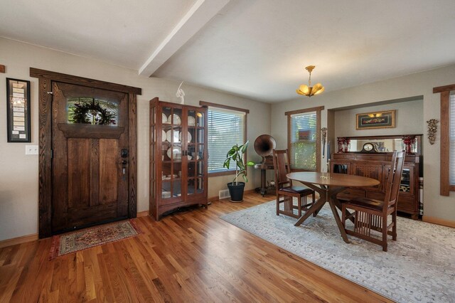 934 E 38th Ave, Spokane, WA 99203 - entrance foyer with wood finished floors, beam ceiling, and a chandelier