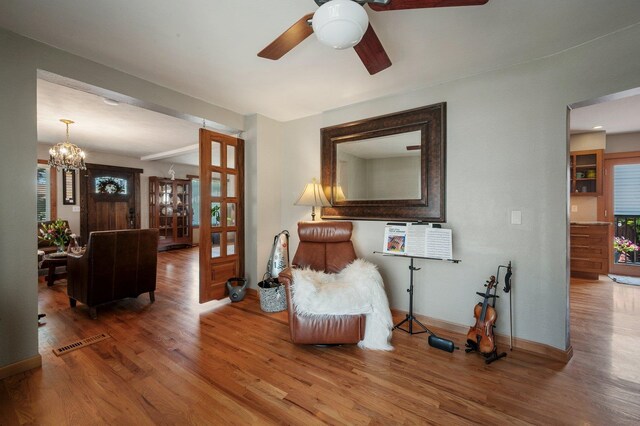 934 E 38th Ave, Spokane, WA 99203 - living area with ceiling fan, wood finished floors, and a chandelier