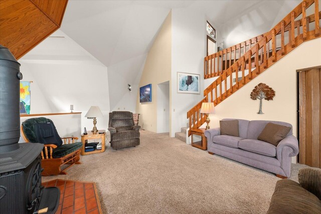 1470 State Route 174th Rte, Grand Coulee, WA 99133 - carpeted living room featuring stairway, a wood stove, and high vaulted ceiling