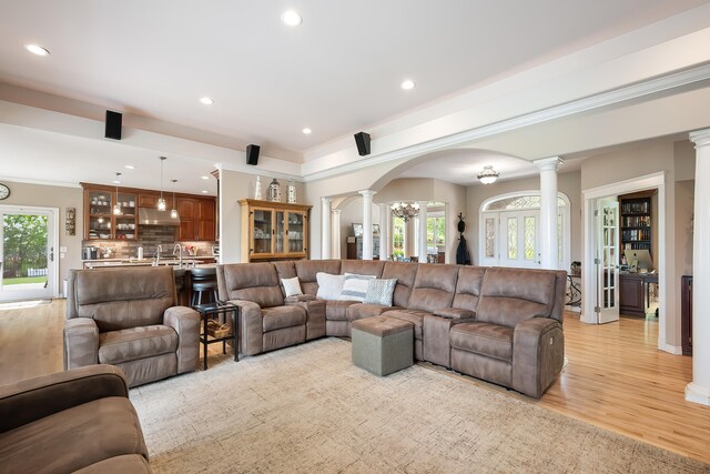 13411 S Bluegrouse Ln, Spokane, WA 99224 - living room with ornate columns, arched walkways, recessed lighting, light wood-style floors, and plenty of natural light