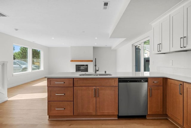 101 S W St, Chewelah, WA 99109 - kitchen with dishwasher, a sink, open floor plan, light countertops, and light wood finished floors