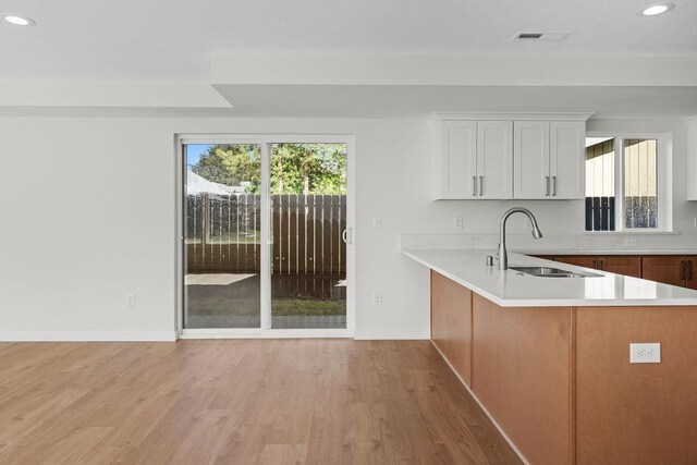 101 S W St, Chewelah, WA 99109 - kitchen featuring a sink, light countertops, recessed lighting, light wood-style flooring, and baseboards