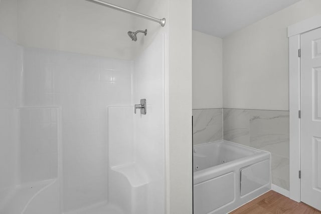 101 S W St, Chewelah, WA 99109 - bathroom featuring a garden tub, a shower, and wood finished floors