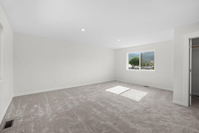 101 S W St, Chewelah, WA 99109 - unfurnished bedroom featuring carpet floors, baseboards, recessed lighting, and a walk in closet