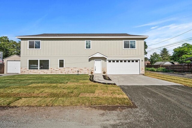 101 S W St, Chewelah, WA 99109 - traditional-style house with asphalt driveway, stone siding, and an attached garage