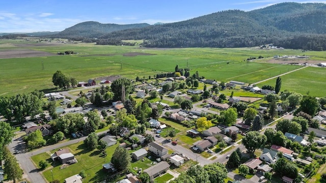 101 S W St, Chewelah, WA 99109 - aerial view of property's location with a mountainous background, rural landscape, and agricultural land
