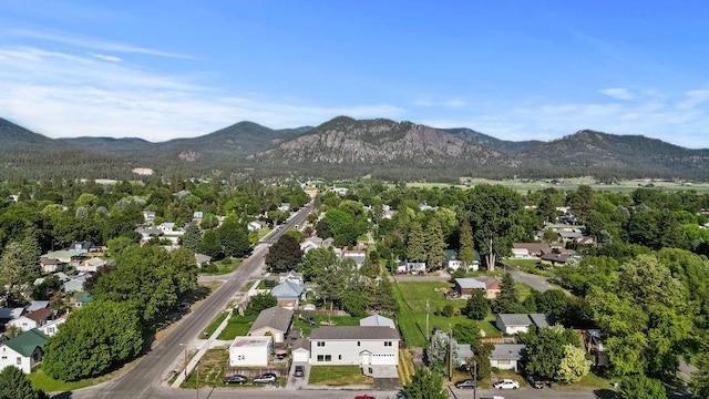 101 S W St, Chewelah, WA 99109 - aerial view of property and surrounding area featuring mountains and nearby suburban area