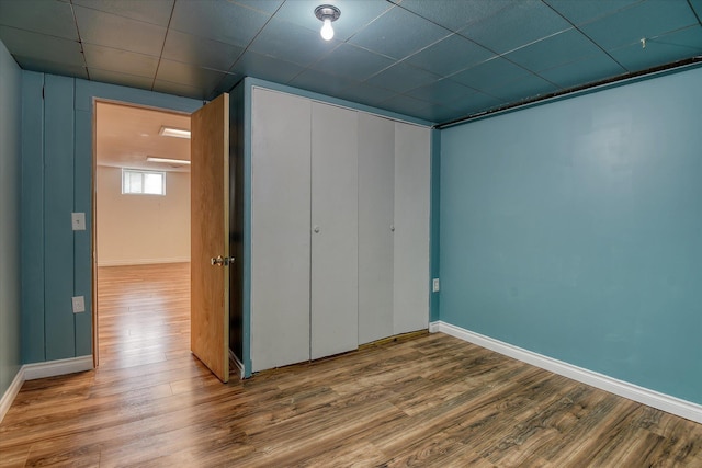2729 W Broad Ave, Spokane, WA 99205 - unfurnished bedroom featuring wood finished floors, a closet, baseboards, and a drop ceiling