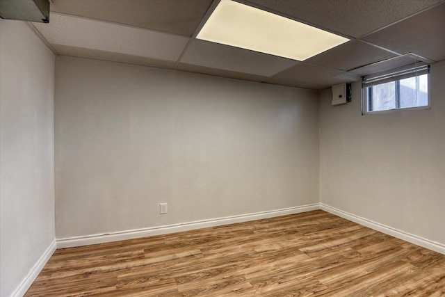 2729 W Broad Ave, Spokane, WA 99205 - below grade area with wood finished floors, a paneled ceiling, and baseboards