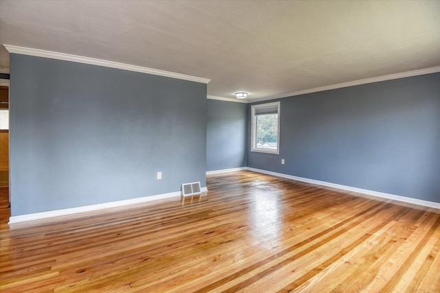 2729 W Broad Ave, Spokane, WA 99205 - spare room with wood finished floors, crown molding, and baseboards