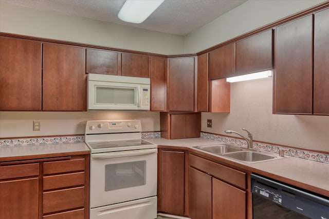707 W 6th Ave # 33, Spokane, WA 99204 - kitchen featuring white appliances, a sink, light countertops, and a textured ceiling
