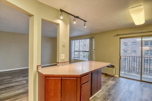 707 W 6th Ave # 33, Spokane, WA 99204 - kitchen with wood finished floors, light countertops, track lighting, and baseboards