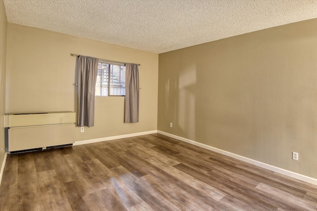 707 W 6th Ave # 33, Spokane, WA 99204 - empty room with a textured ceiling, wood finished floors, and baseboards