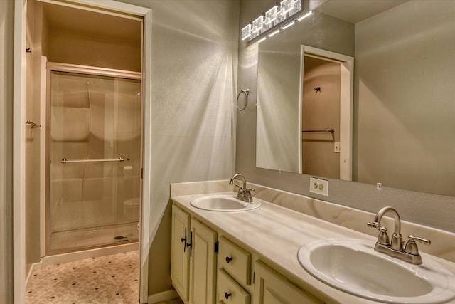 707 W 6th Ave # 33, Spokane, WA 99204 - full bathroom featuring a shower stall, double vanity, and baseboards