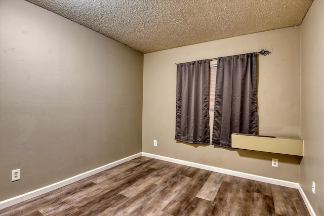 707 W 6th Ave # 33, Spokane, WA 99204 - unfurnished room with wood finished floors, baseboards, and a textured ceiling