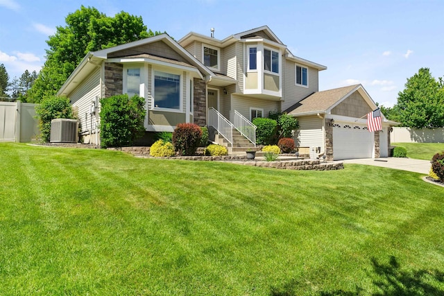 1212 S Drummond Rd, Greenacres, WA 99016 - view of front facade featuring stone siding, central AC, driveway, and a garage