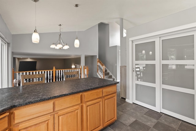 1212 S Drummond Rd, Greenacres, WA 99016 - kitchen featuring a chandelier, vaulted ceiling, decorative light fixtures, dark stone finish flooring, and dark stone countertops