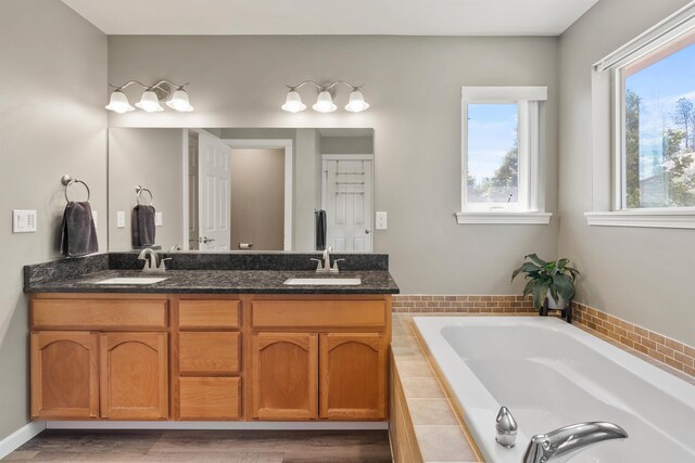 1212 S Drummond Rd, Greenacres, WA 99016 - bathroom with double vanity, a bath, and wood finished floors