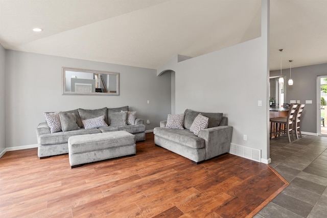 1212 S Drummond Rd, Greenacres, WA 99016 - living room with baseboards, arched walkways, lofted ceiling, and wood finished floors