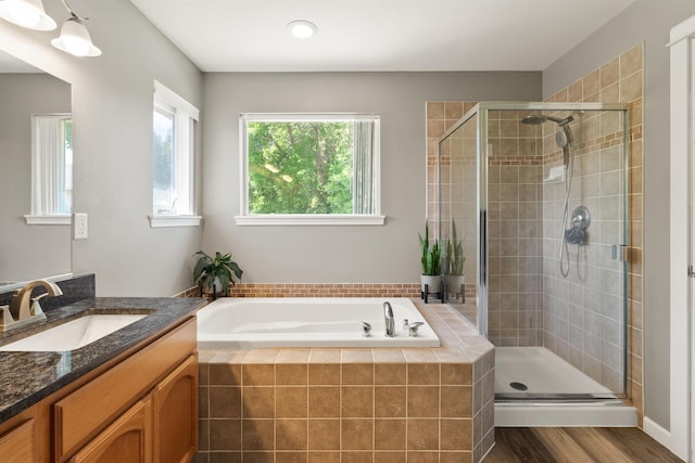 1212 S Drummond Rd, Greenacres, WA 99016 - bathroom with vanity, a garden tub, a stall shower, wood finished floors, and recessed lighting