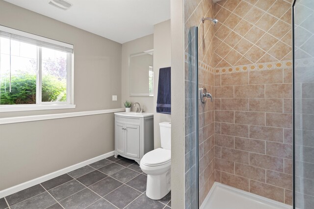 1212 S Drummond Rd, Greenacres, WA 99016 - bathroom featuring vanity, tile patterned flooring, a tile shower, toilet, and baseboards