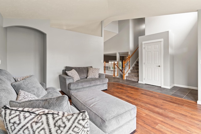 1212 S Drummond Rd, Greenacres, WA 99016 - living area featuring stairway, arched walkways, wood finished floors, baseboards, and lofted ceiling