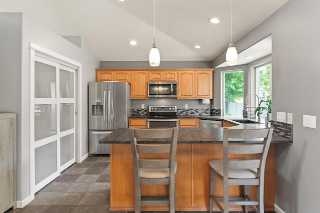 1212 S Drummond Rd, Greenacres, WA 99016 - kitchen with appliances with stainless steel finishes, a sink, lofted ceiling, dark countertops, and a peninsula