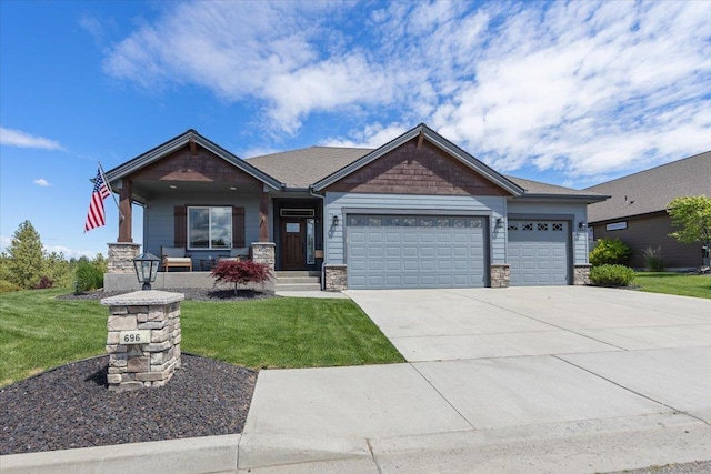 696 W Basalt Ridge Dr, Spokane, WA 99224 - craftsman-style house with an attached garage, driveway, a front lawn, and stone siding