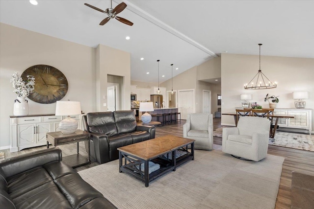 696 W Basalt Ridge Dr, Spokane, WA 99224 - living area with ceiling fan, wood finished floors, a chandelier, and high vaulted ceiling