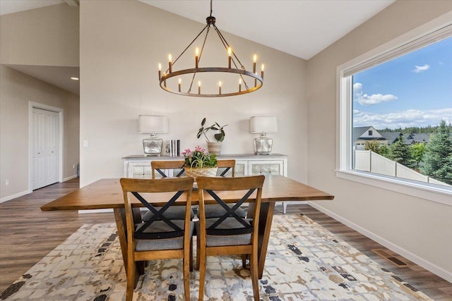 696 W Basalt Ridge Dr, Spokane, WA 99224 - dining area featuring a chandelier, baseboards, wood finished floors, and vaulted ceiling