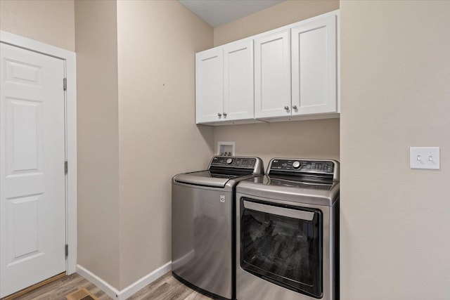 696 W Basalt Ridge Dr, Spokane, WA 99224 - washroom featuring independent washer and dryer, cabinet space, light wood-style floors, and baseboards