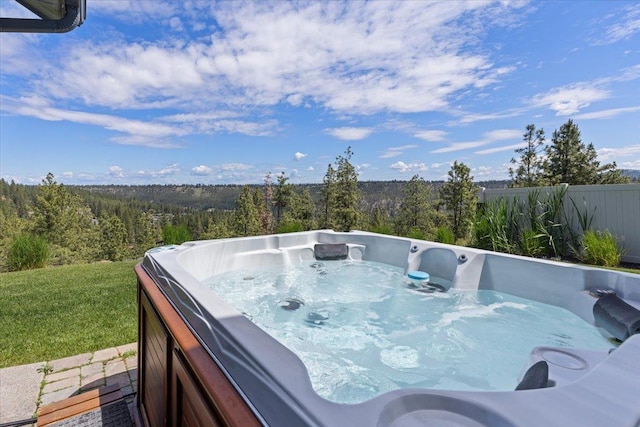 696 W Basalt Ridge Dr, Spokane, WA 99224 - view of patio / terrace with a view of trees and a hot tub