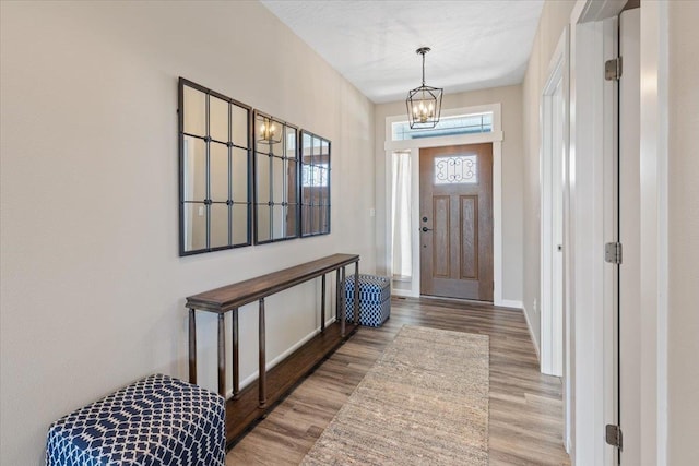 696 W Basalt Ridge Dr, Spokane, WA 99224 - foyer with wood finished floors, a chandelier, and baseboards