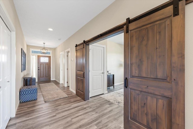696 W Basalt Ridge Dr, Spokane, WA 99224 - entrance foyer featuring a barn door, light wood-style floors, baseboards, and recessed lighting