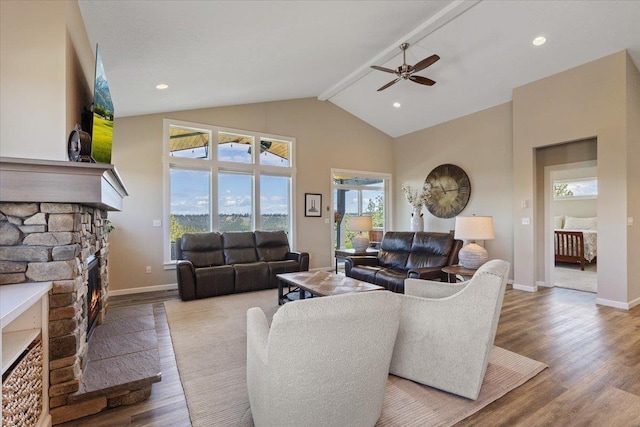 696 W Basalt Ridge Dr, Spokane, WA 99224 - living area with a fireplace, beam ceiling, wood finished floors, a ceiling fan, and high vaulted ceiling