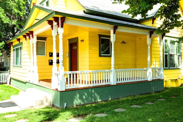 1702 W Dean Ave, Spokane, WA 99201 - shotgun-style home featuring covered porch and a front lawn