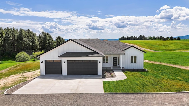 8521 W Dahl Rd, Deer Park, WA 99006 - modern farmhouse style home featuring a garage, board and batten siding, concrete driveway, and a front lawn
