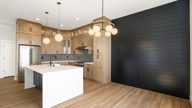 8521 W Dahl Rd, Deer Park, WA 99006 - kitchen featuring under cabinet range hood, high quality fridge, a chandelier, tasteful backsplash, and light countertops