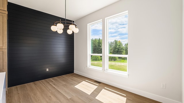 8521 W Dahl Rd, Deer Park, WA 99006 - empty room featuring baseboards, a chandelier, and light wood-type flooring