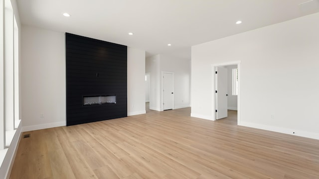 8521 W Dahl Rd, Deer Park, WA 99006 - unfurnished living room with light wood finished floors, a fireplace, recessed lighting, and baseboards