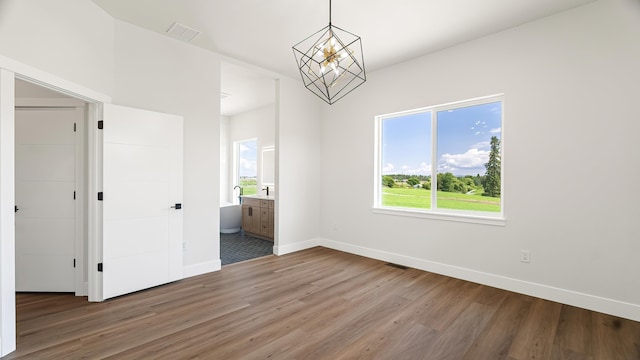 8521 W Dahl Rd, Deer Park, WA 99006 - empty room with a chandelier, light wood-type flooring, and baseboards