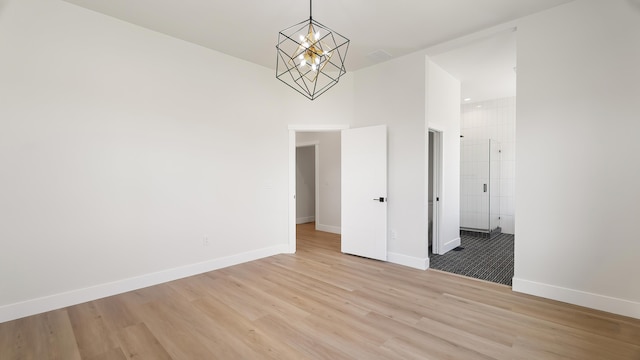 8521 W Dahl Rd, Deer Park, WA 99006 - unfurnished dining area featuring light wood-type flooring, a chandelier, and baseboards