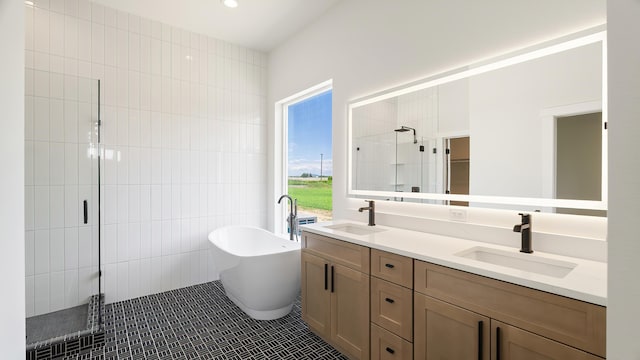 8521 W Dahl Rd, Deer Park, WA 99006 - bathroom featuring a stall shower, double vanity, a freestanding tub, tile walls, and tile patterned flooring